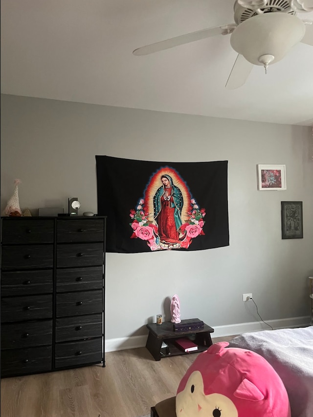 bedroom with ceiling fan and hardwood / wood-style flooring