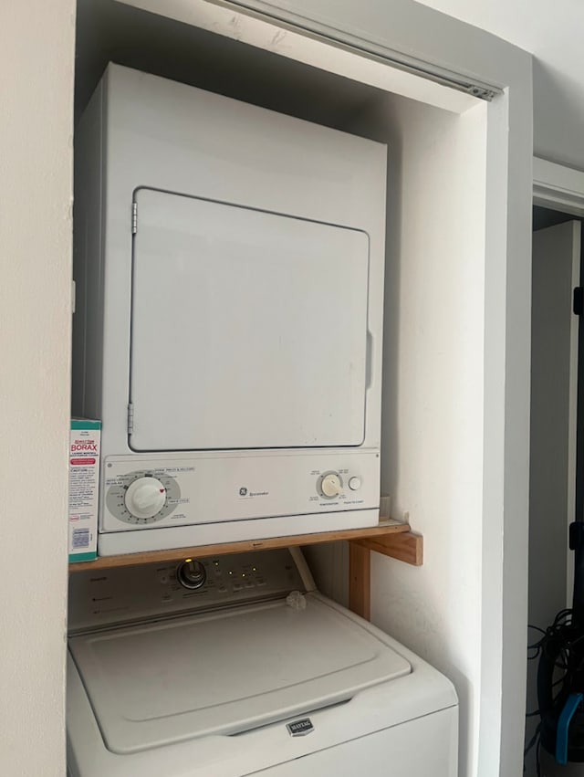 laundry area featuring stacked washer / dryer