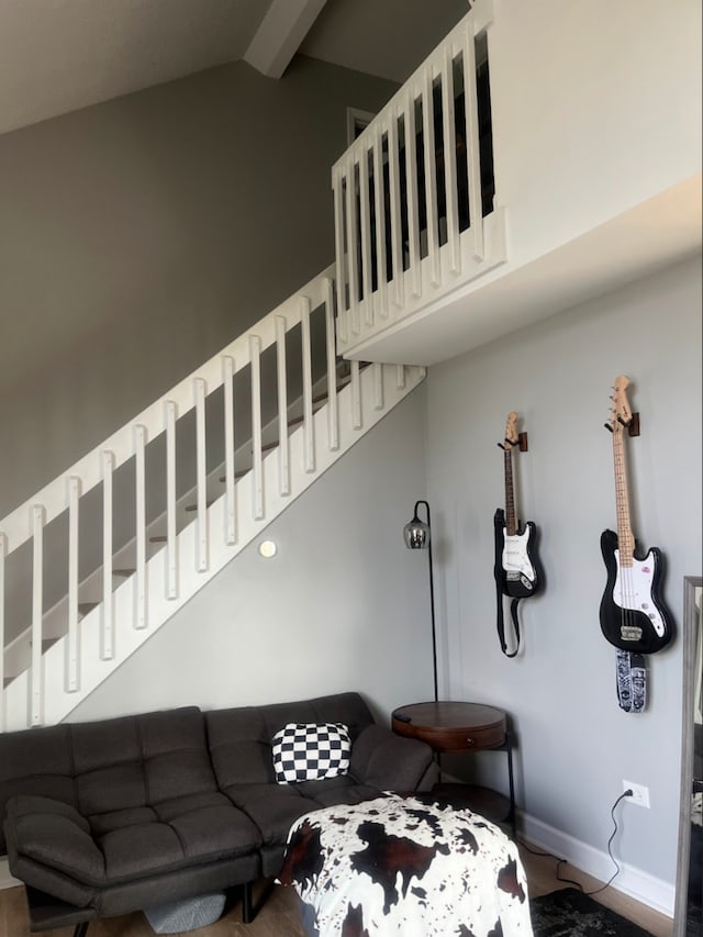 living room with lofted ceiling with beams