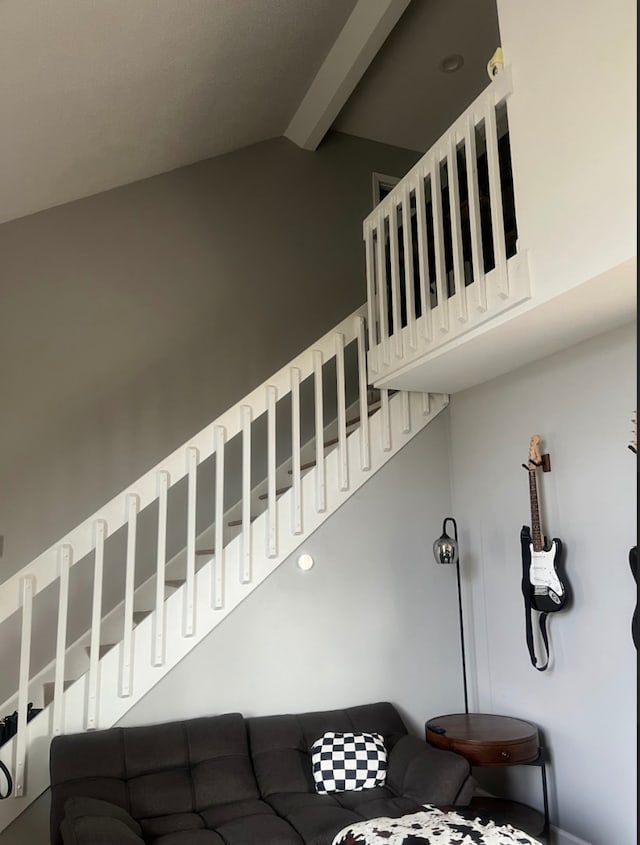 stairs with lofted ceiling with beams