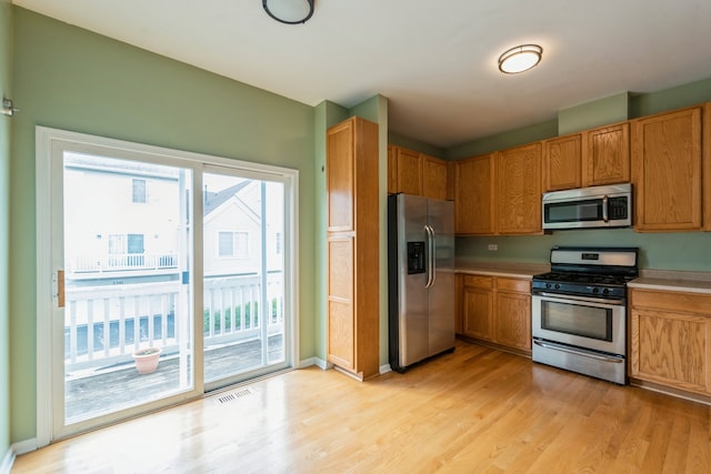 kitchen featuring light wood-type flooring and stainless steel appliances