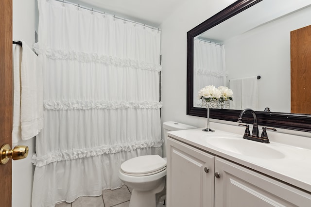 bathroom featuring tile patterned floors, vanity, and toilet