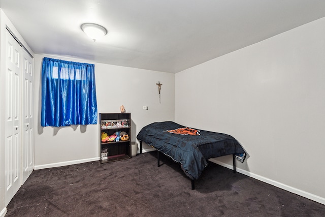 bedroom featuring a closet and dark colored carpet