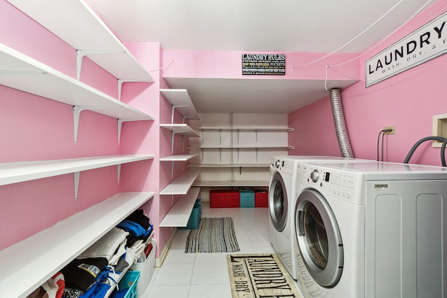 laundry room with light tile patterned floors and washing machine and clothes dryer