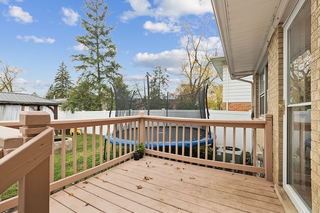 wooden deck featuring a trampoline