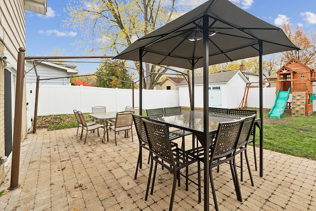 view of patio with a shed and a playground