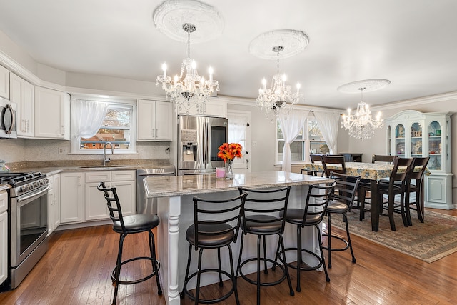 kitchen featuring decorative light fixtures, dark hardwood / wood-style flooring, and appliances with stainless steel finishes