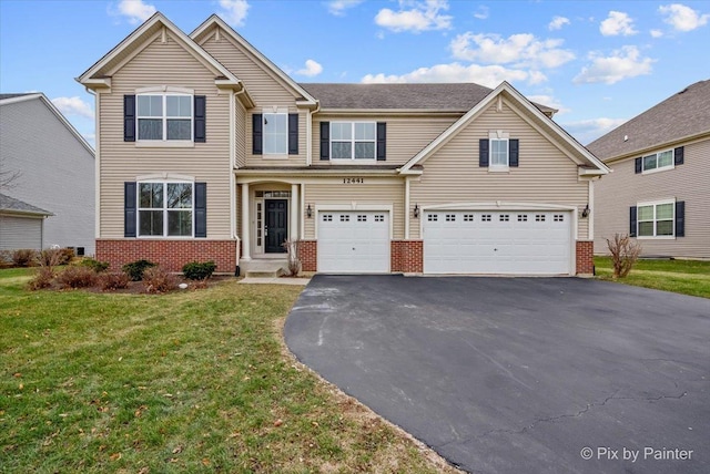 view of front of house featuring a front yard and a garage