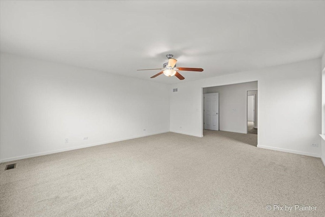 spare room featuring ceiling fan and light colored carpet