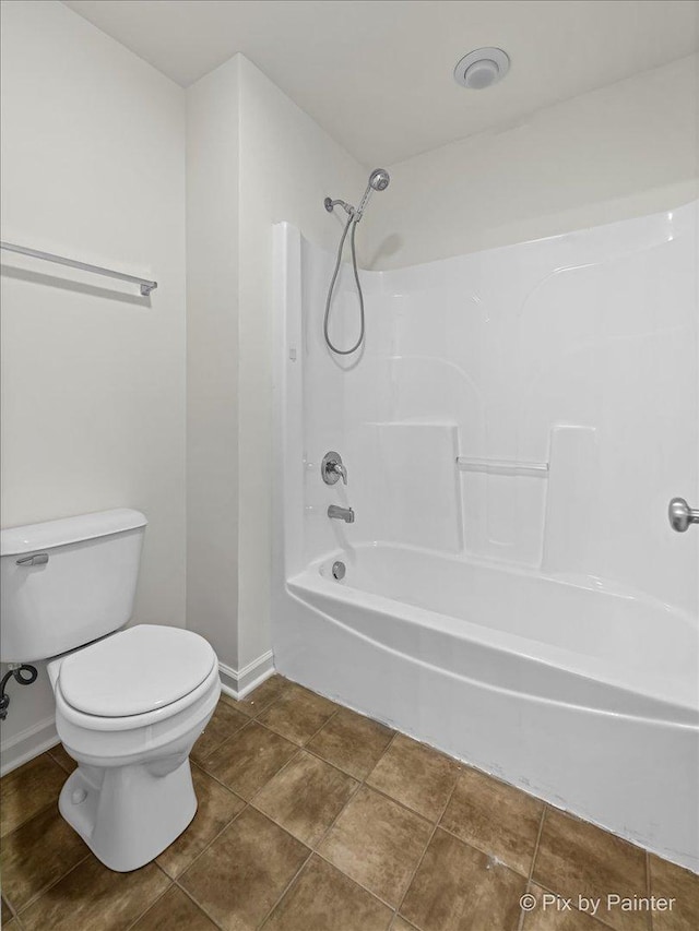 bathroom featuring tub / shower combination and toilet