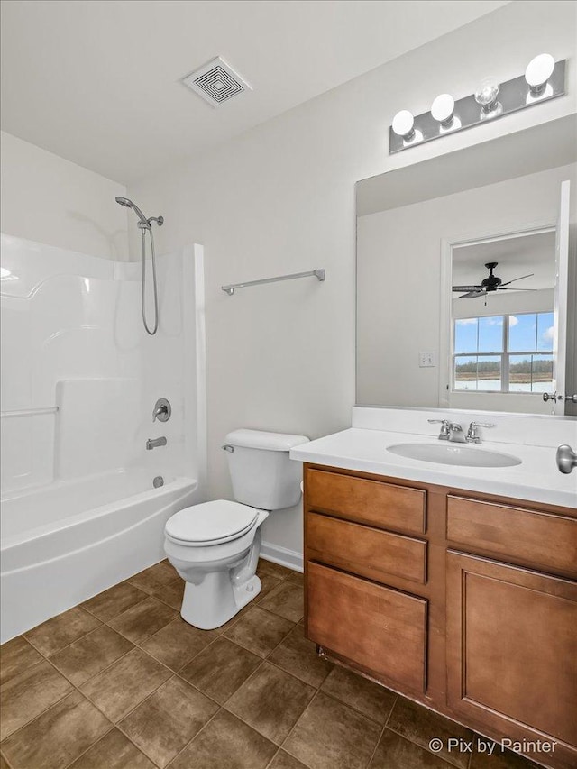 full bathroom with ceiling fan, tile patterned floors, shower / bath combination, toilet, and vanity