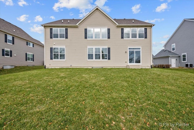 back of house featuring a lawn