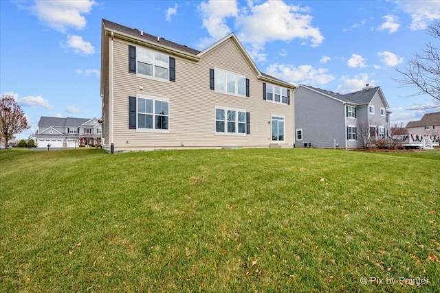 rear view of house featuring a lawn