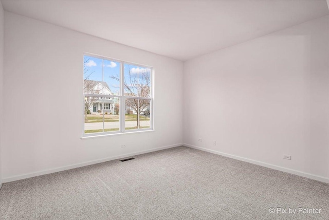 carpeted empty room with a wealth of natural light