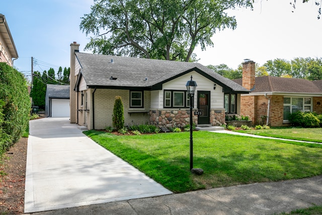 ranch-style house with a front yard, an outbuilding, and a garage