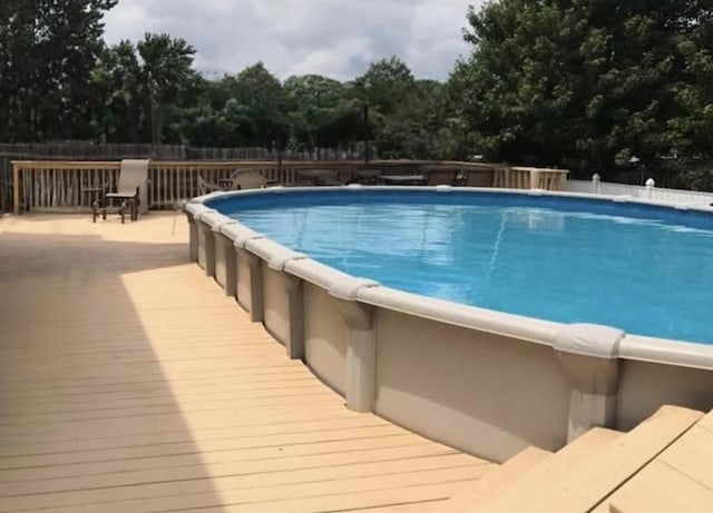 view of pool with a wooden deck