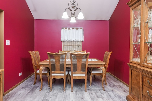 dining area with a chandelier and light wood-type flooring