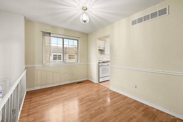 unfurnished room with light hardwood / wood-style floors