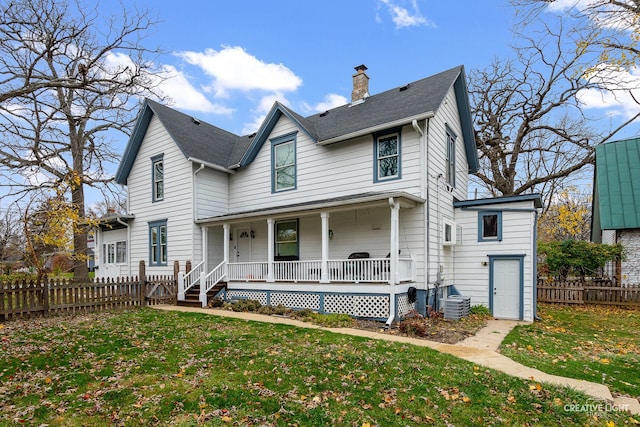 view of front facade featuring central AC, a front lawn, and covered porch