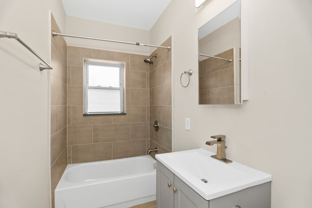 bathroom featuring vanity and tiled shower / bath combo