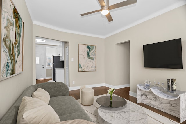 living room with crown molding, hardwood / wood-style floors, and ceiling fan