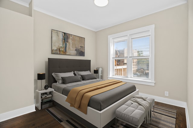 bedroom featuring crown molding and dark hardwood / wood-style floors