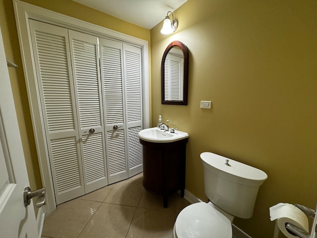 bathroom with tile patterned flooring, vanity, and toilet