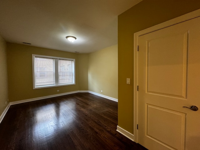 unfurnished room featuring dark hardwood / wood-style floors