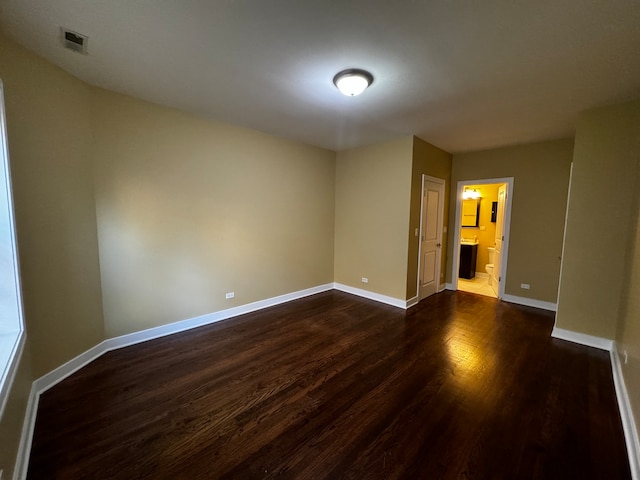 empty room with dark hardwood / wood-style floors