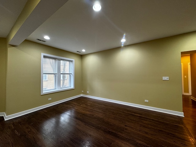 empty room with dark hardwood / wood-style floors