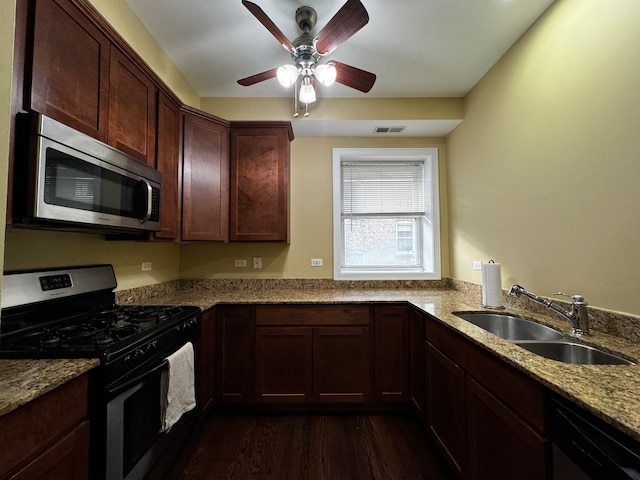 kitchen featuring light stone counters, ceiling fan, sink, black appliances, and dark hardwood / wood-style floors