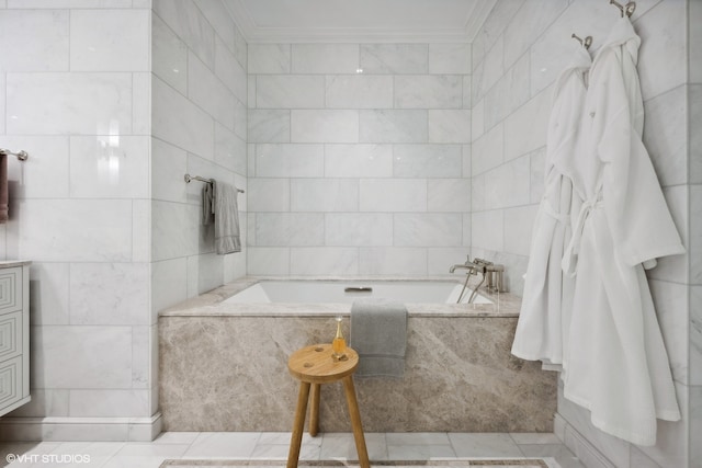 bathroom with tiled bath, crown molding, tile patterned flooring, and tile walls