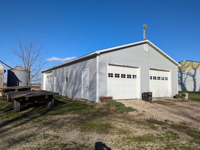 exterior space featuring an outbuilding and a garage