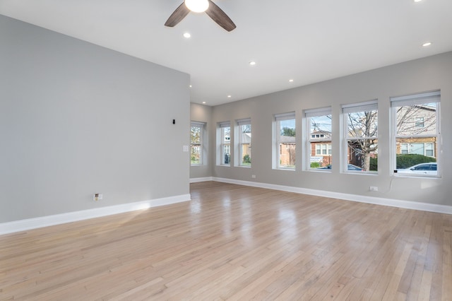 unfurnished room featuring light hardwood / wood-style floors and ceiling fan