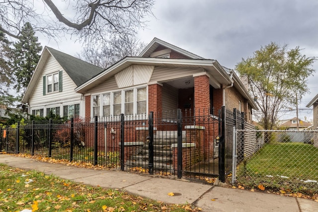 8138 S Harper Ave, Chicago, IL 60619 - bungalow with brick siding, a fenced front yard, and a gate