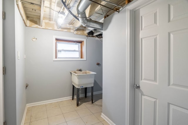 clothes washing area featuring light tile patterned flooring