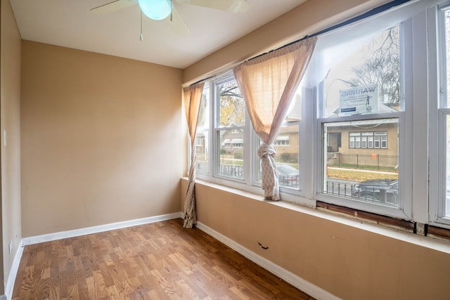 unfurnished room with ceiling fan, a healthy amount of sunlight, and light hardwood / wood-style flooring