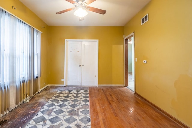 interior space featuring ceiling fan, a closet, and wood-type flooring