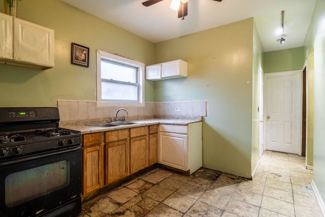 kitchen with ceiling fan, black gas stove, and sink