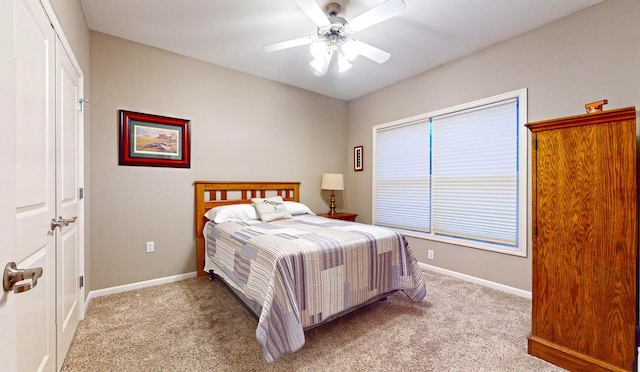 carpeted bedroom with ceiling fan and a closet