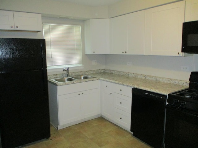 kitchen featuring black appliances, white cabinets, and sink