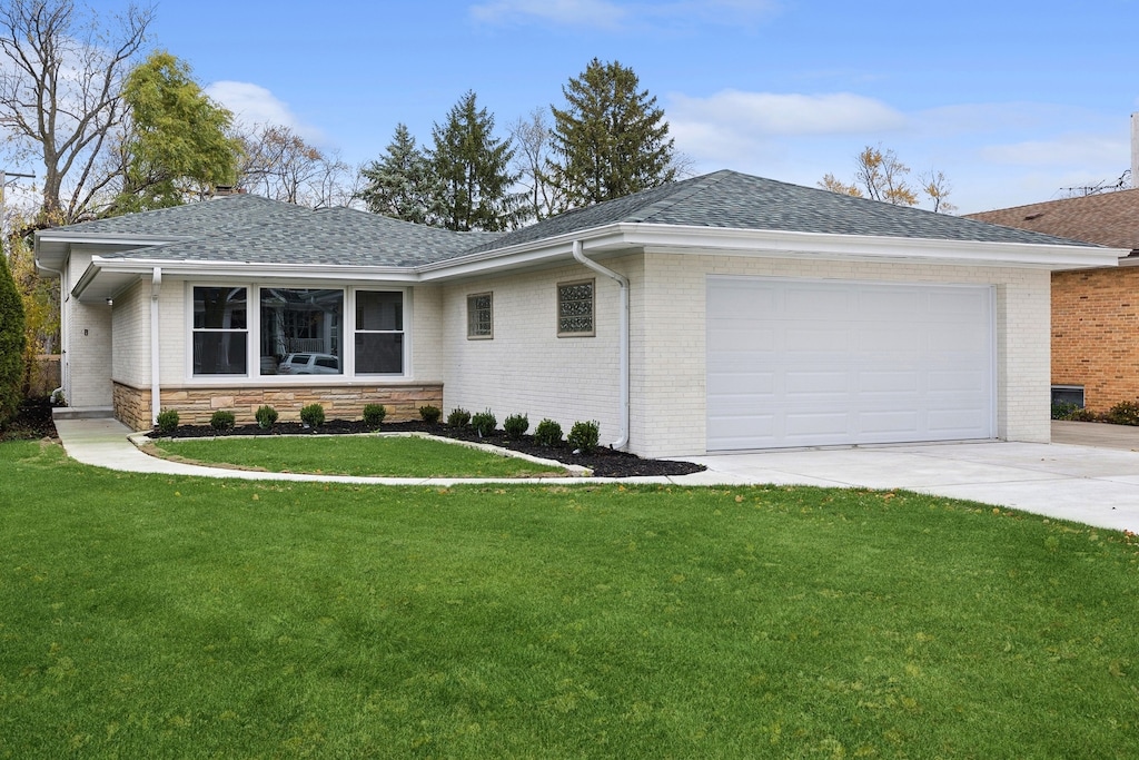 single story home with a front yard and a garage