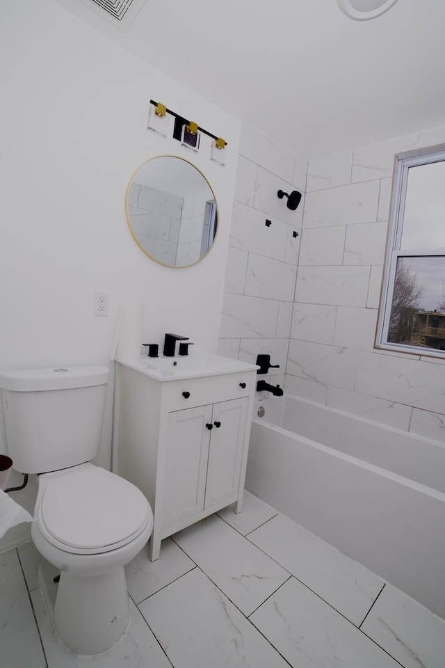 full bathroom with vanity, tiled shower / bath combo, and toilet