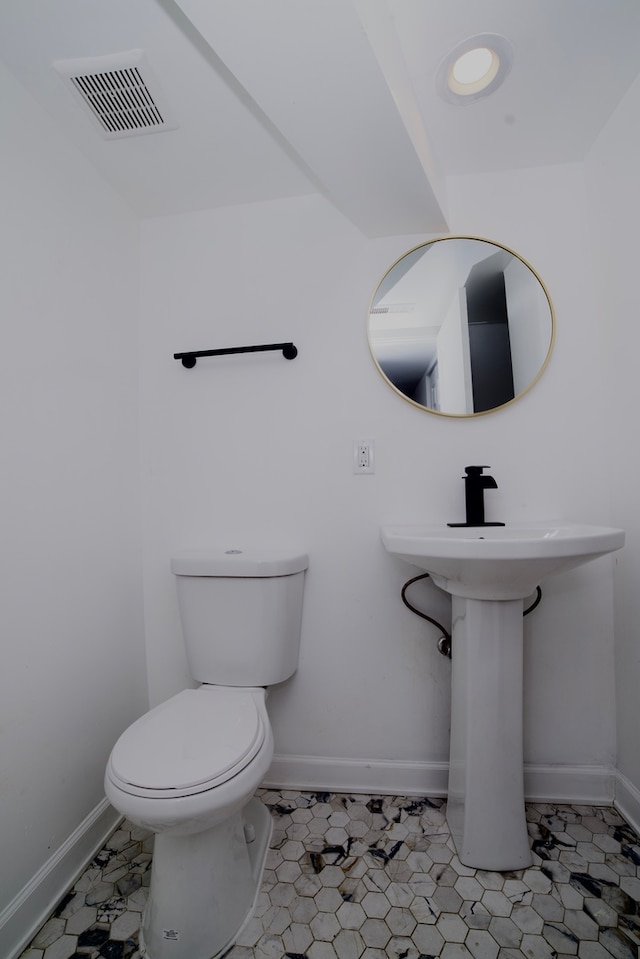 bathroom with tile patterned flooring and toilet