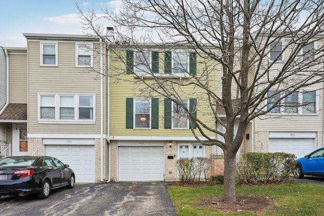 townhome / multi-family property featuring a garage