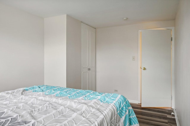 bedroom featuring dark hardwood / wood-style floors and a closet