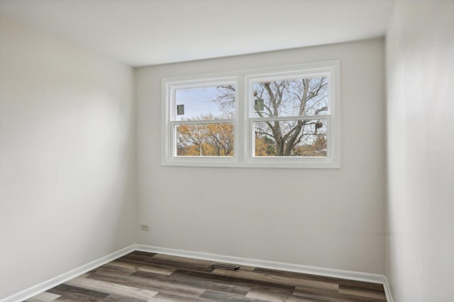 unfurnished room featuring dark hardwood / wood-style flooring