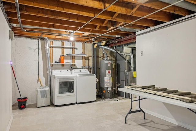 interior space featuring heating unit, water heater, and independent washer and dryer