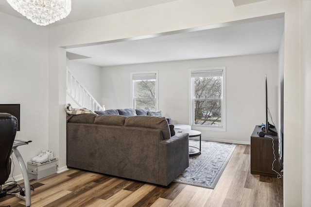 living room with hardwood / wood-style flooring and an inviting chandelier