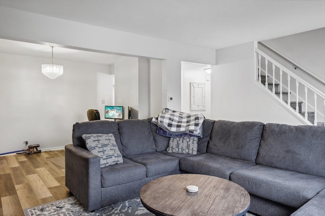 living room featuring a chandelier and hardwood / wood-style floors